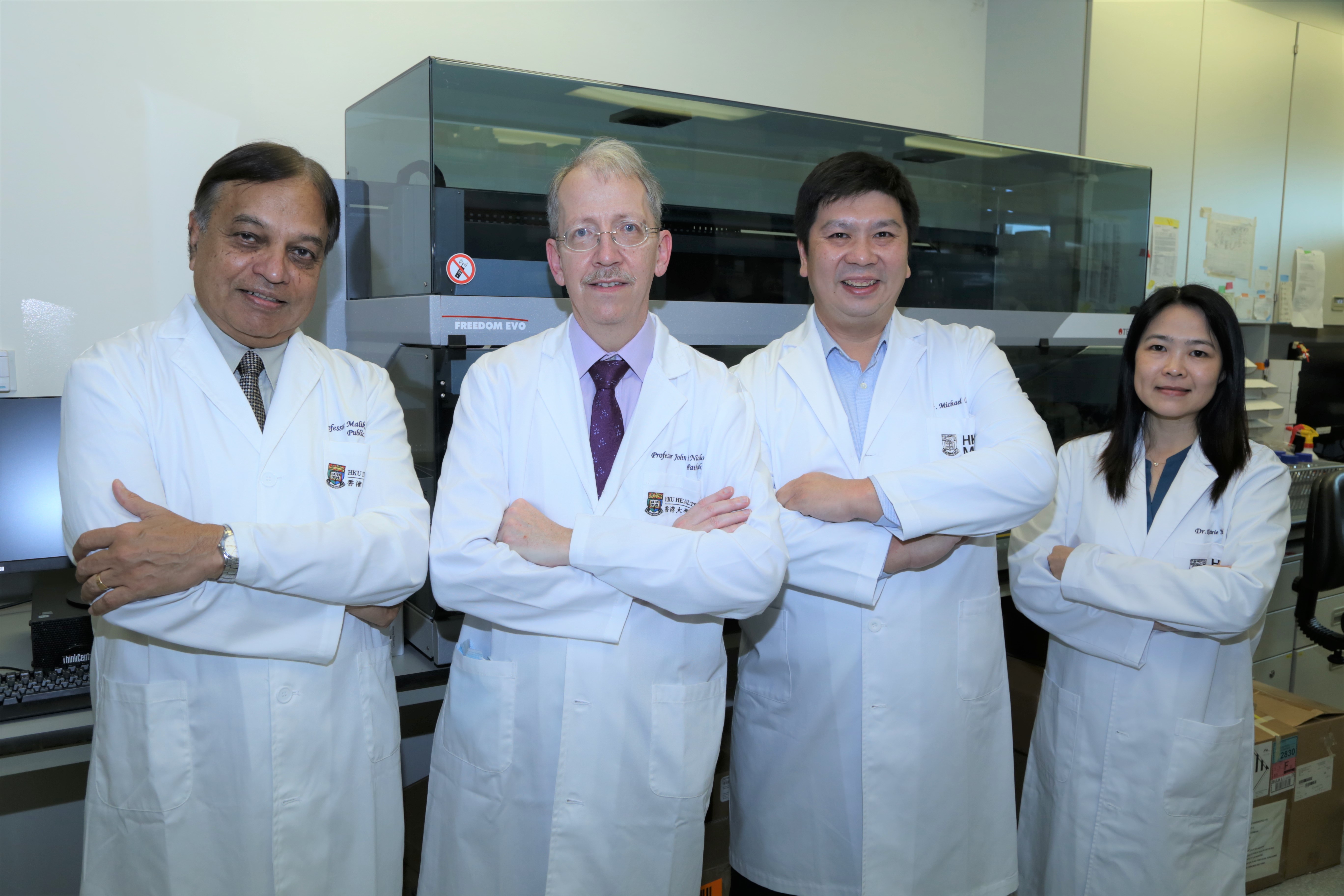 Members of the research team, including Professor Malik Peiris, Professor John Nicholls, Dr Michael Chan, and Dr Kenrie Hui, in a laboratory. 