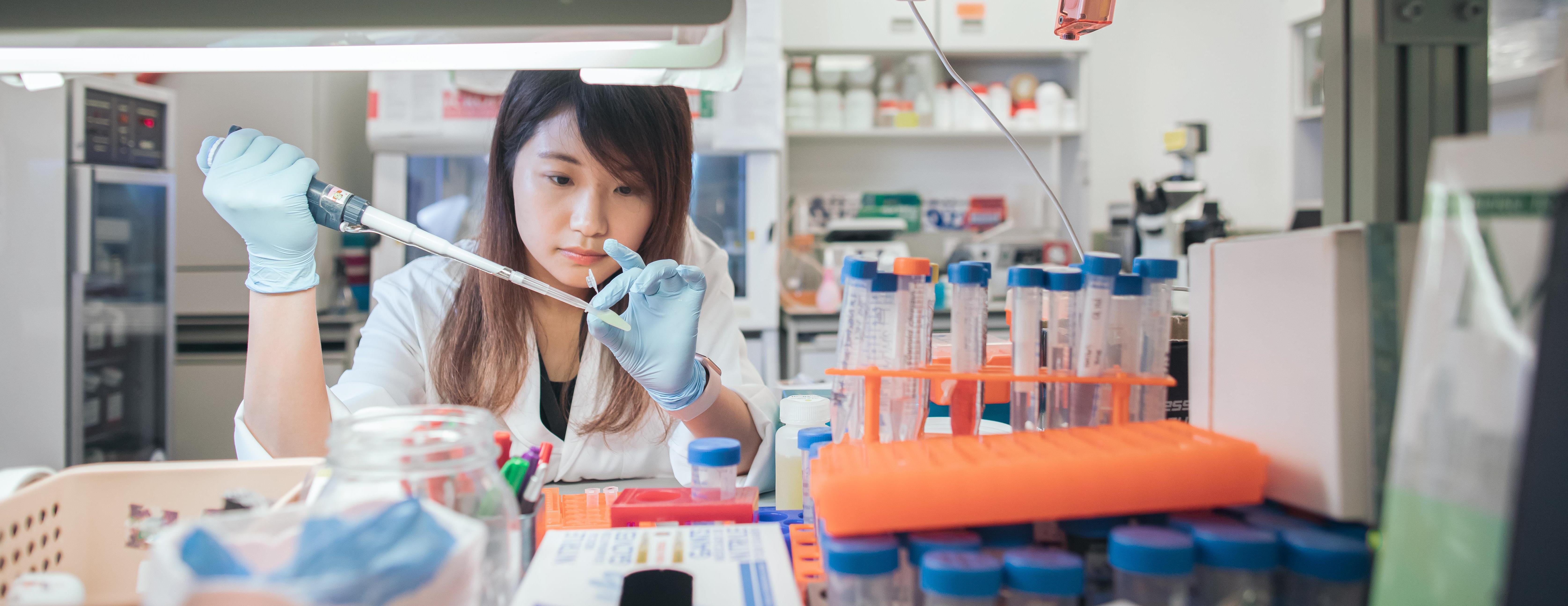 A student doing experiment in a lab setting.