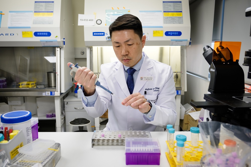 Professor Ivan Hung using an experiment apparatus.